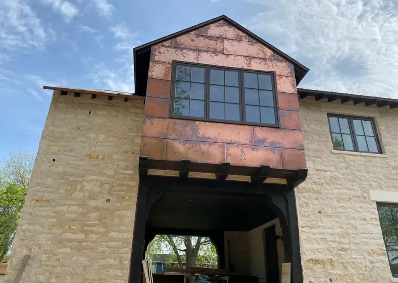 Copper metal panel facade on a stone building for Skylight Installation in Lovejoy